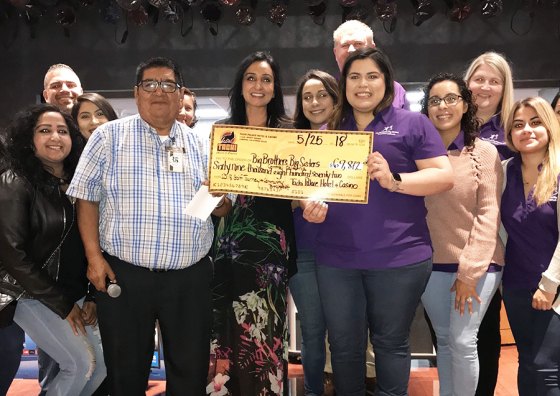 Tachi Palace Hotel & Casino with members of Central California Big Brothers, Big Sisters as he presents them with a check for $70,408.